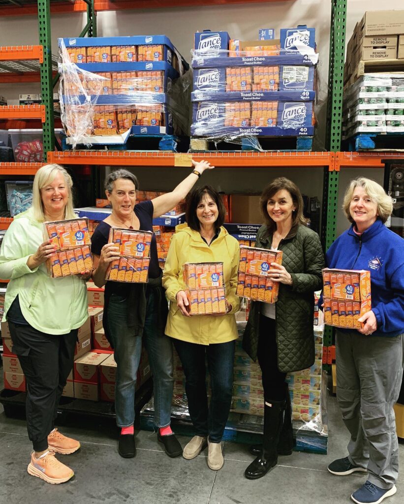 Campbell employees pose in front of pallets of Campbell Snacks