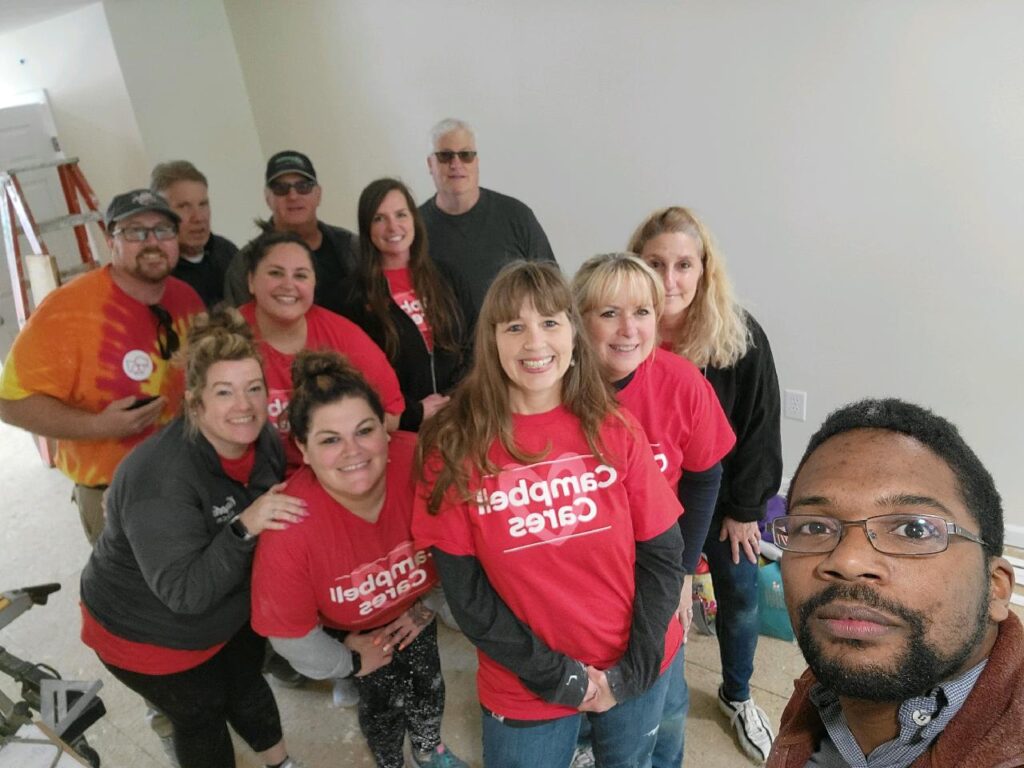 Selfie with Campbell employees at Habitat for Humanity