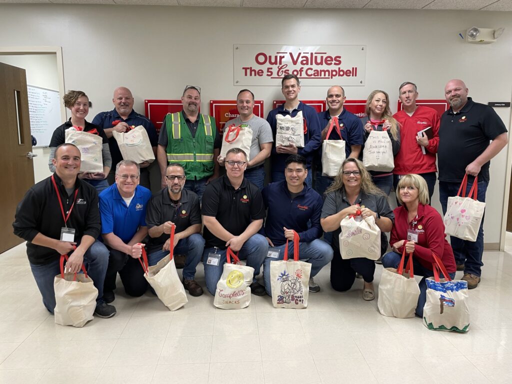 Hanover employees pose with donated tote bags