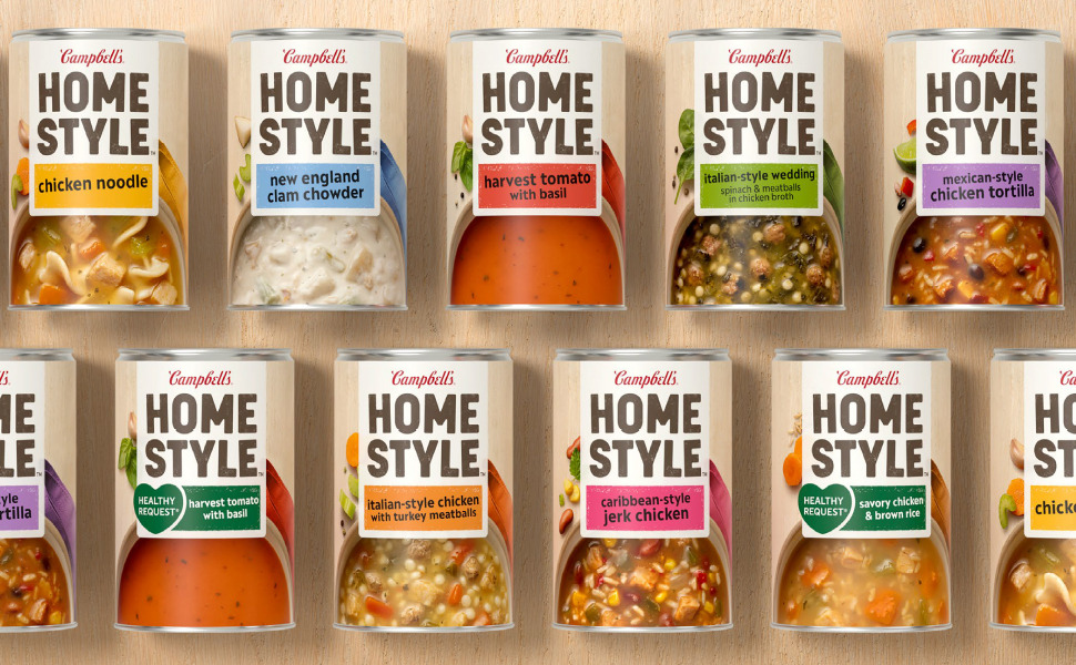 Various Campbell's Home Style soup cans stacked. Flavors include, Chicken Noodle, New England Clam Chowder, Harvest Tomato with Basil, Italian-style Wedding, Mexican-style Chicken Tortilla, Caribbean-style Jerk Chicken, and Italian-style Chicken with Turkey Meatballs